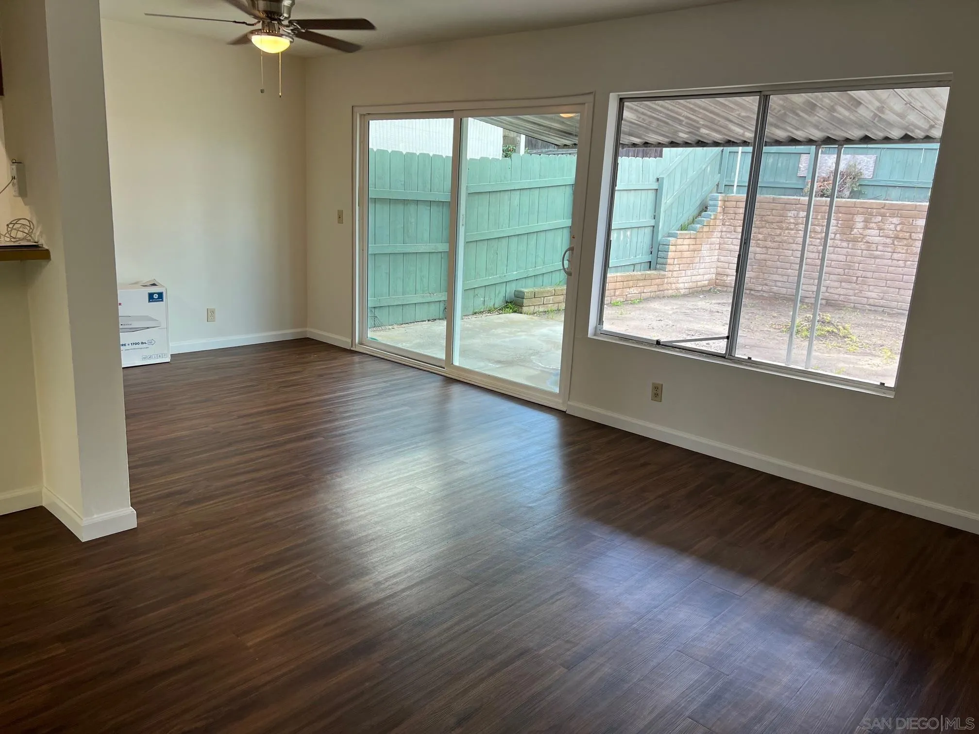 2018 Terracina Circle Spring Valley, CA 91977 - Photo 3 of 24 a view of an empty room with wooden floor and a window