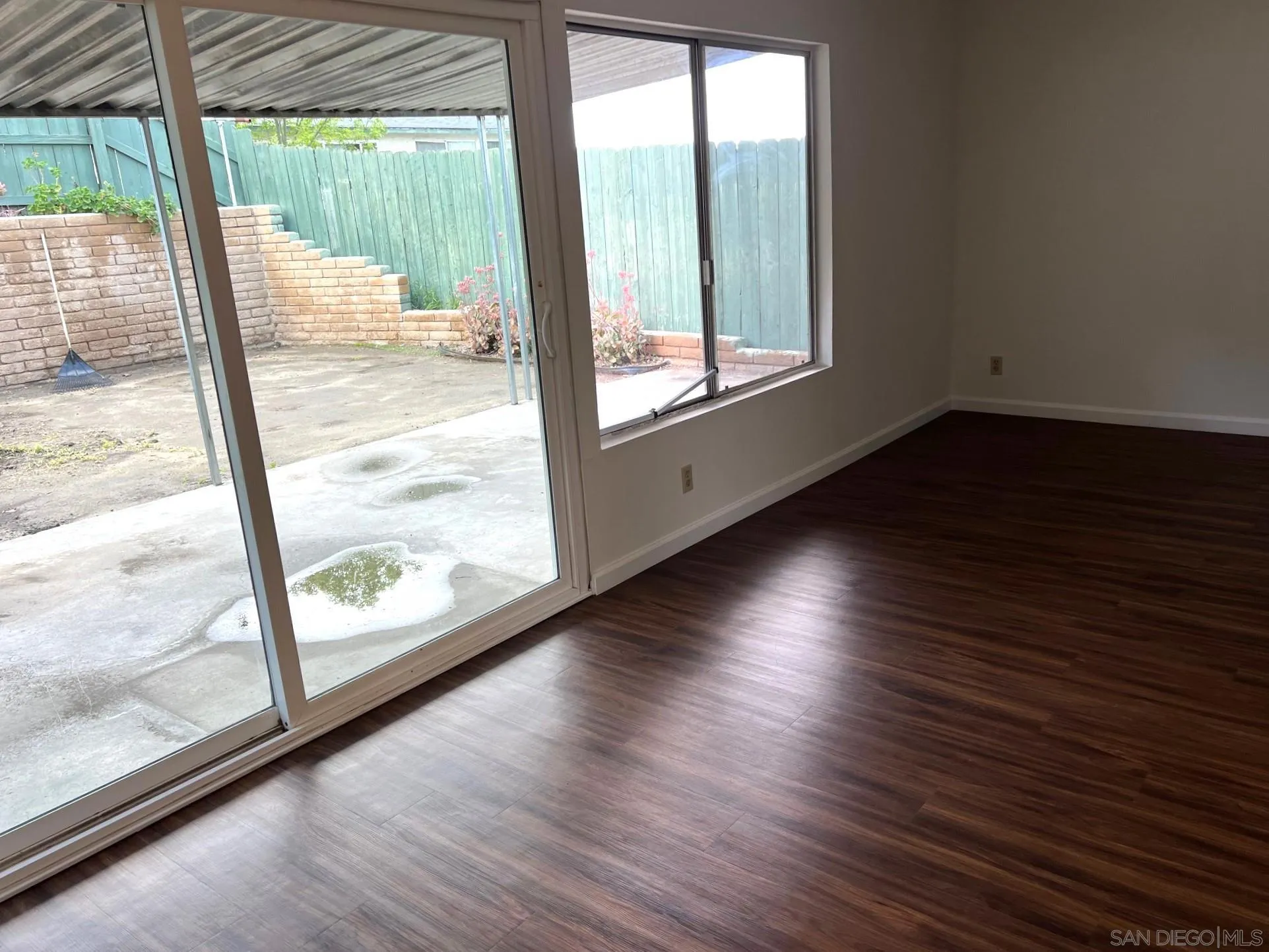 2018 Terracina Circle Spring Valley, CA 91977 - Photo 4 of 24 a view of an empty room with wooden floor and a window