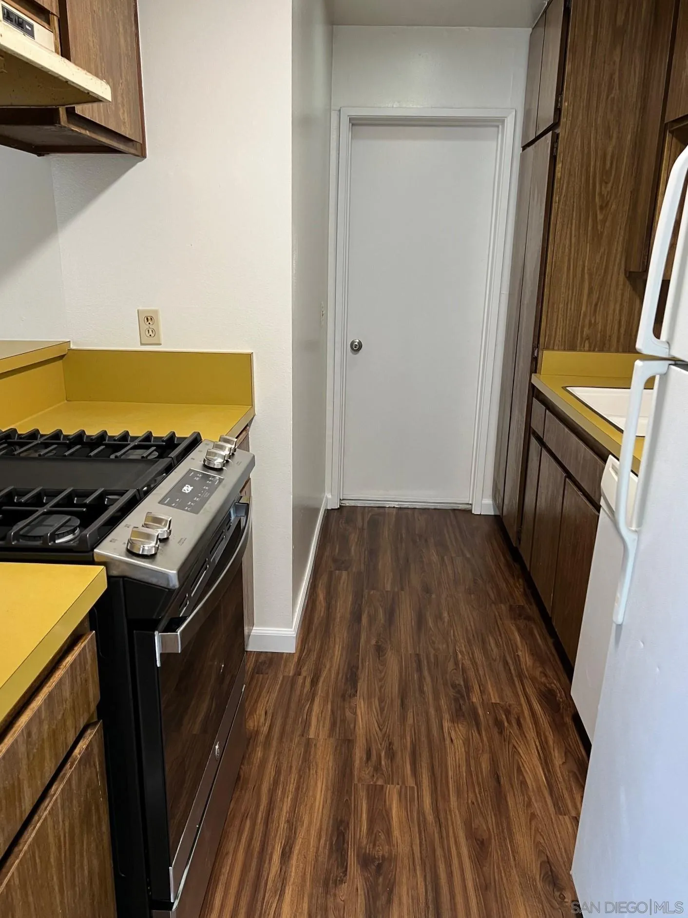 2018 Terracina Circle Spring Valley, CA 91977 - Photo 5 of 24 a kitchen with wooden floors and a sink