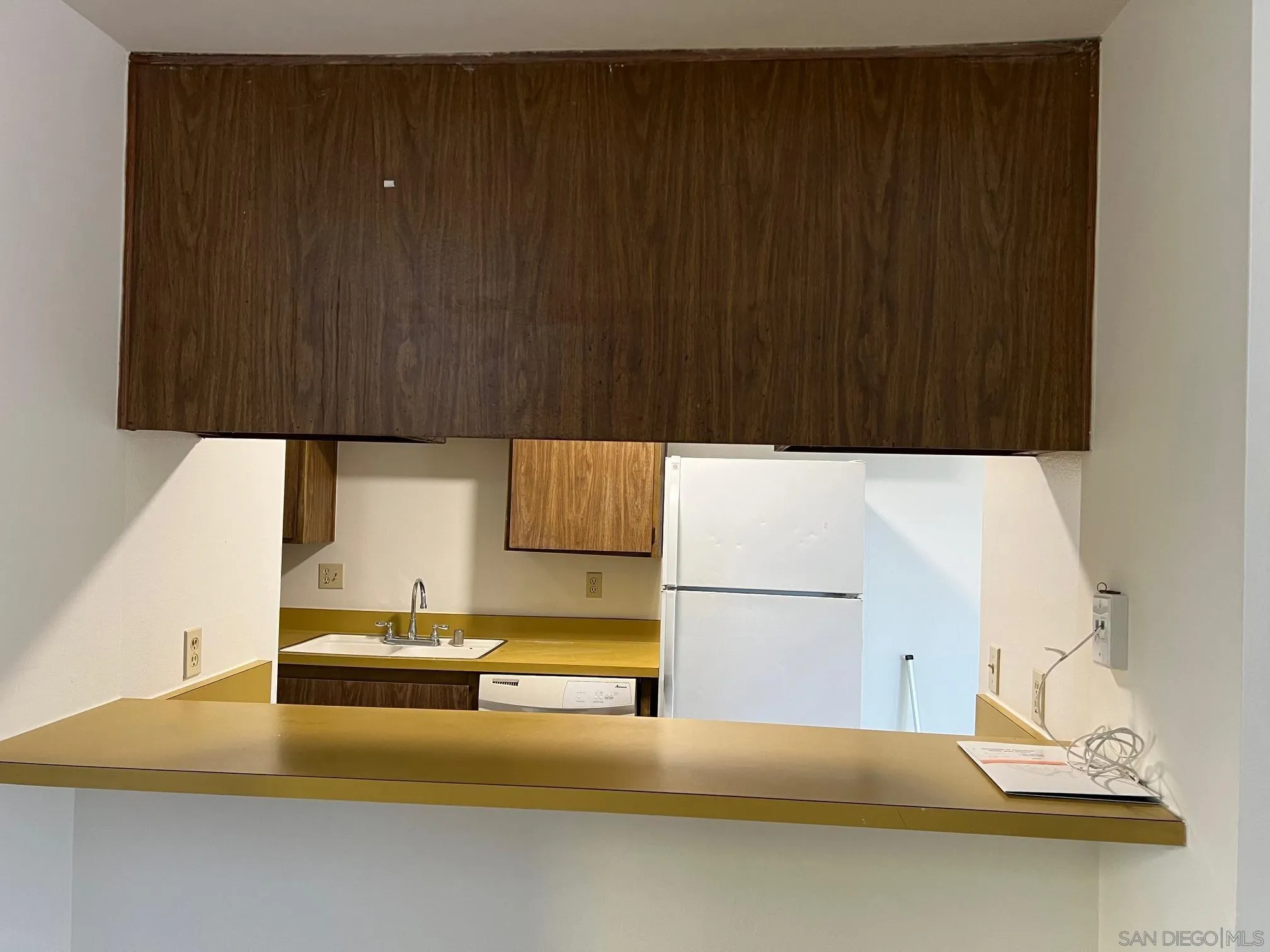 2018 Terracina Circle Spring Valley, CA 91977 - Photo 8 of 24 a kitchen with a sink dishwasher and a stove with wooden cabinets
