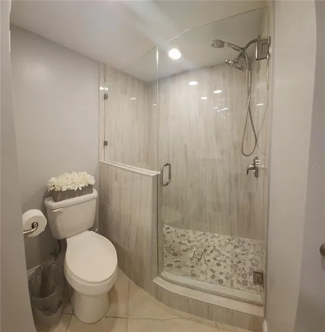 a bathroom with a toilet and shower