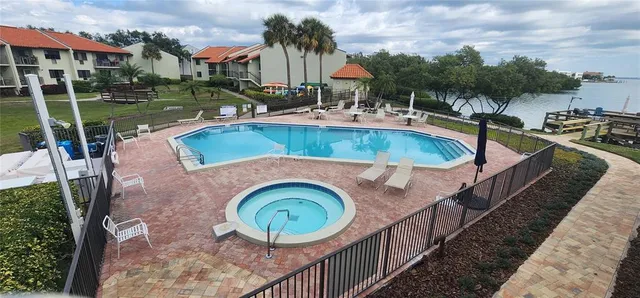 an aerial view of a house with swimming pool and outdoor seating