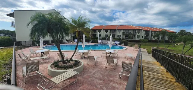 a view of a house with swimming pool and sitting area