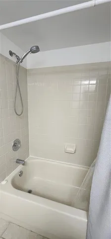 a bathroom with a bathtub and shower