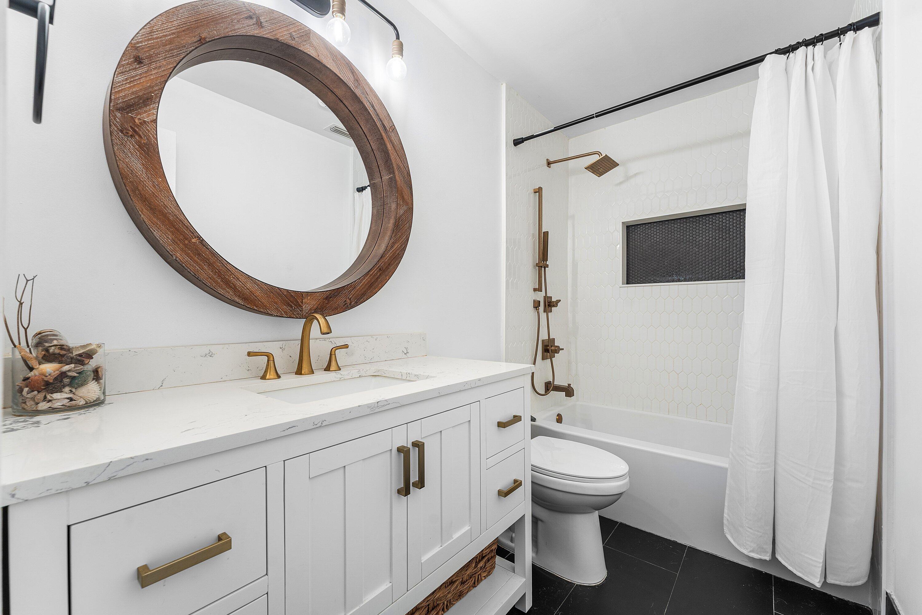 581 Northwest 13th Drive Boca Raton, FL 33486 - Photo 33 of 39 a bathroom with a toilet a sink and a mirror