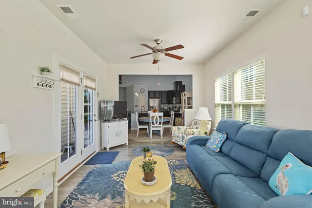 a living room with furniture a fireplace and a chandelier