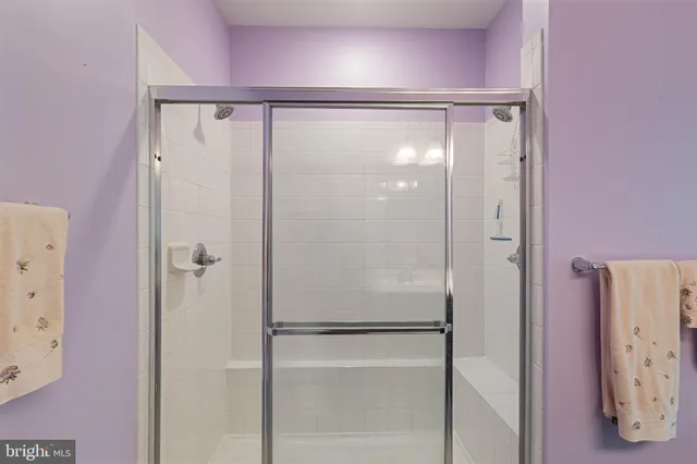 a bathroom with a glass shower door
