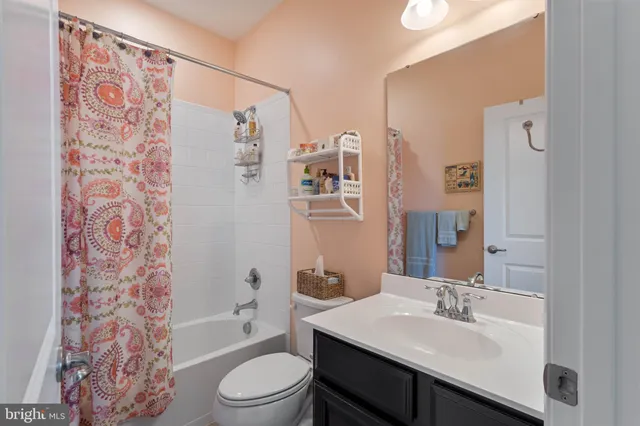 a bathroom with a sink toilet a mirror and shower