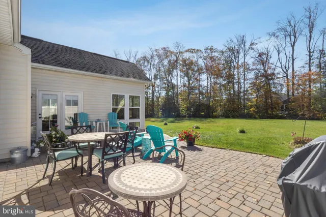 a view of a house with backyard sitting area and garden