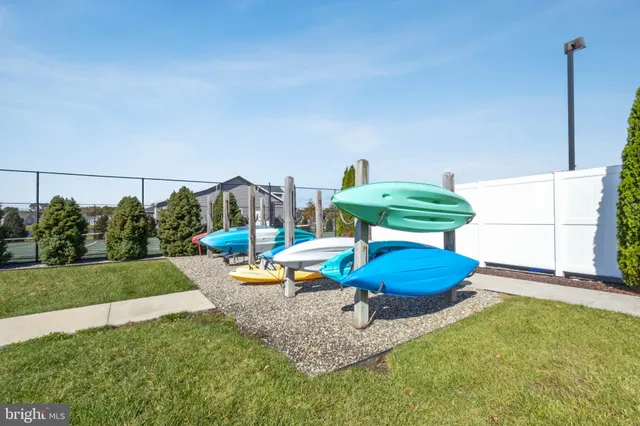 a view of a backyard with couches chair and floor to ceiling window