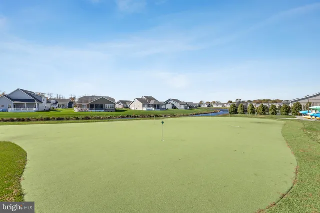 a view of a lake with houses in the background