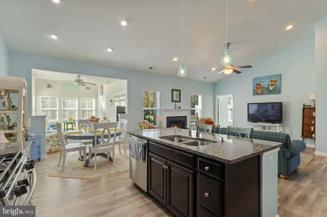 a kitchen with kitchen island granite countertop a sink table and chairs