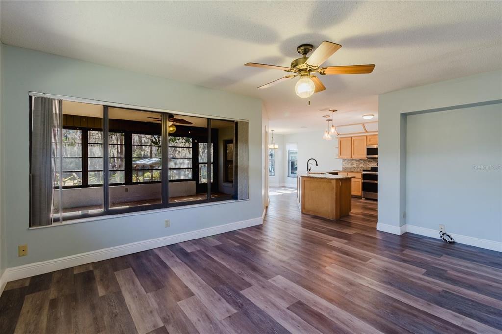 28330 Peterson Camp Road Brooksville, FL 34601 - Photo 14 of 81 a view of a kitchen with wooden floor and a ceiling fan