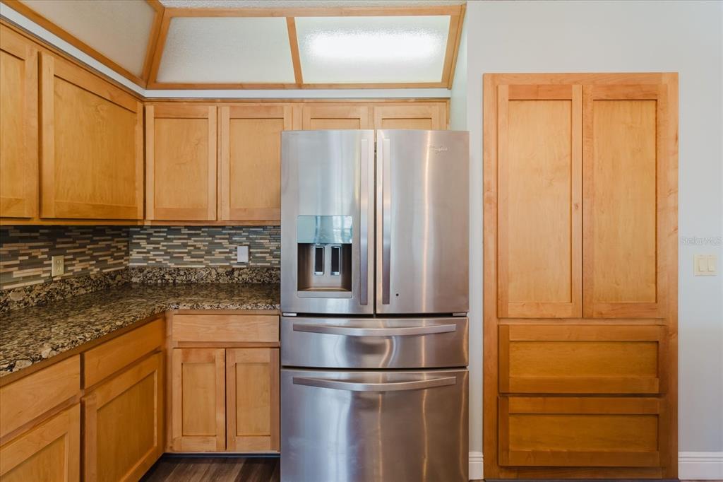 28330 Peterson Camp Road Brooksville, FL 34601 - Photo 22 of 81 a kitchen with appliances cabinets and a wooden floor