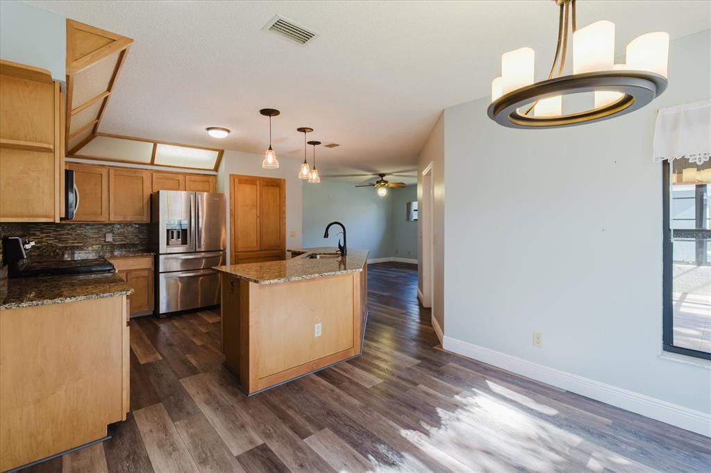 28330 Peterson Camp Road Brooksville, FL 34601 - Photo 24 of 81 a kitchen with stainless steel appliances granite countertop a stove a sink a refrigerator and a microwave