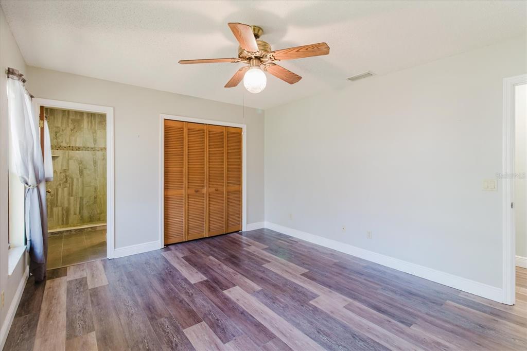28330 Peterson Camp Road Brooksville, FL 34601 - Photo 29 of 81 wooden floor in an empty room with a window