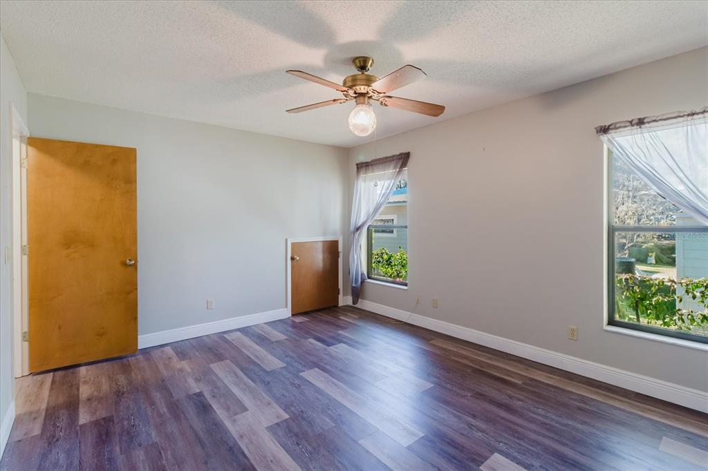 28330 Peterson Camp Road Brooksville, FL 34601 - Photo 31 of 81 a view of an empty room with window and wooden floor