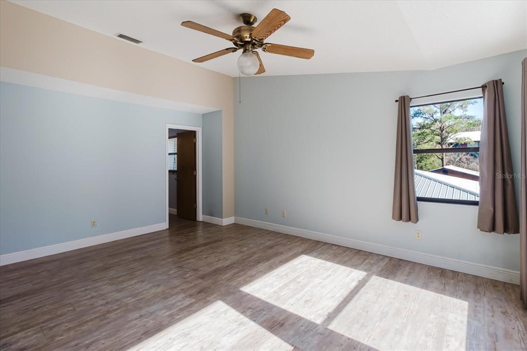 28330 Peterson Camp Road Brooksville, FL 34601 - Photo 44 of 81 wooden floor in an empty room with a window