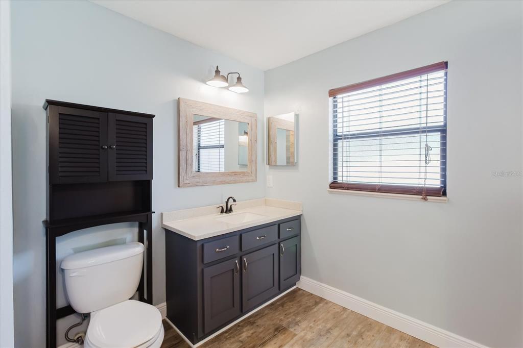 28330 Peterson Camp Road Brooksville, FL 34601 - Photo 46 of 81 a bathroom with a toilet sink and mirror