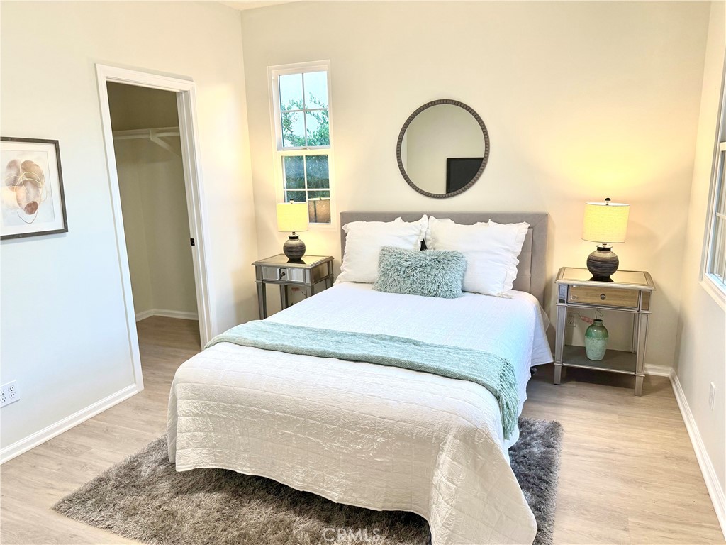 93 Painted Trellis Irvine, CA 92620 - Photo 11 of 12 a bedroom with a bed and a wooden floor