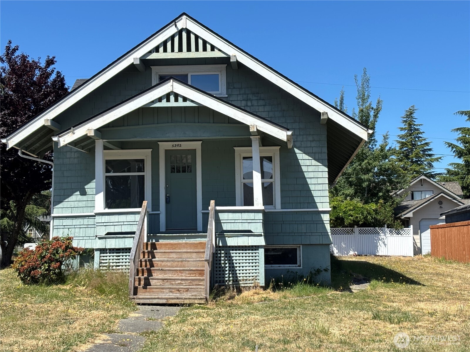 5302 North Shirley Street Ruston, WA 98407 - Photo 1 of 10 a front view of a house with a yard