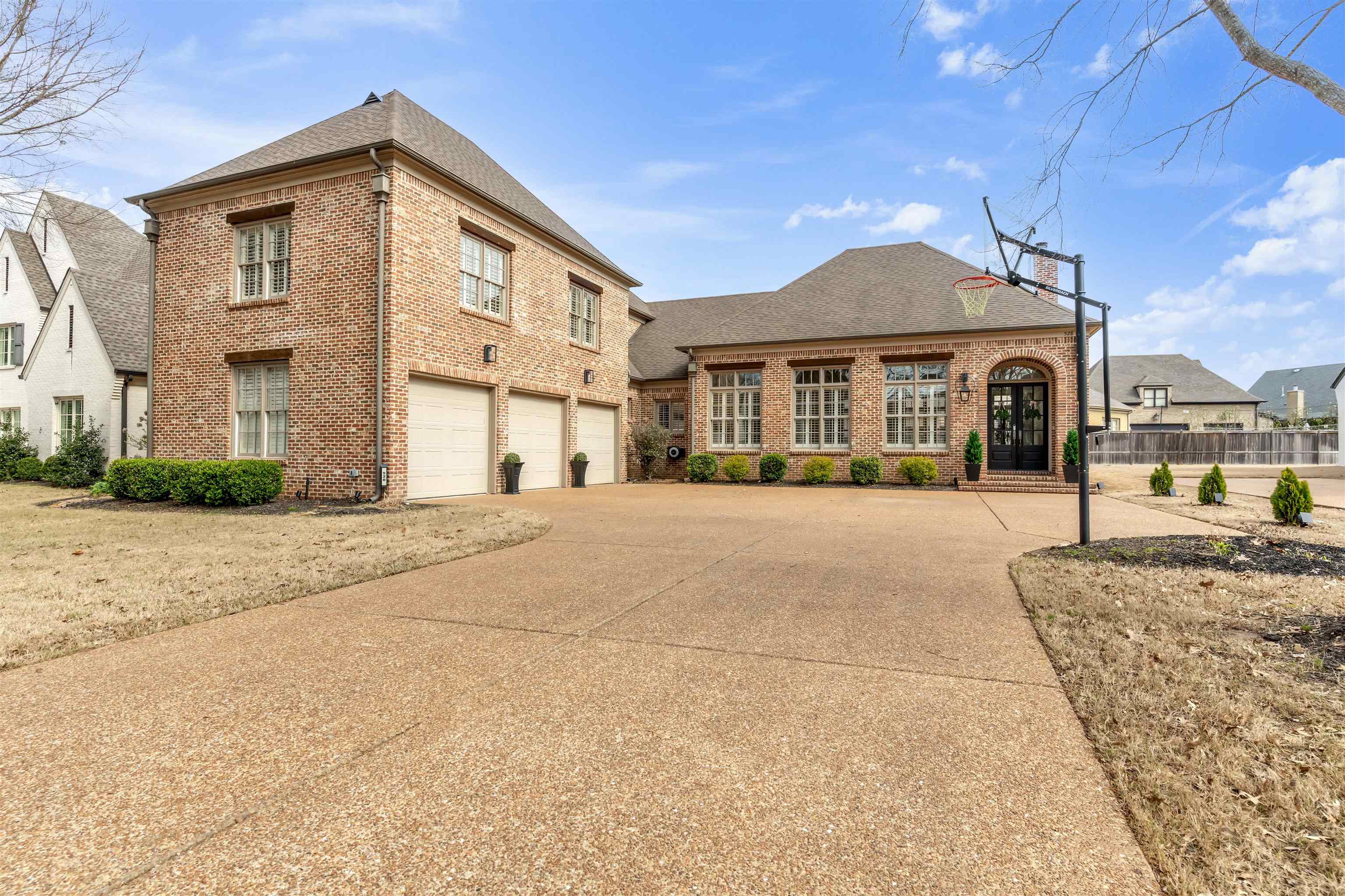View of front of home featuring brick siding, concrete driveway, an attached garage, and roof with shingles