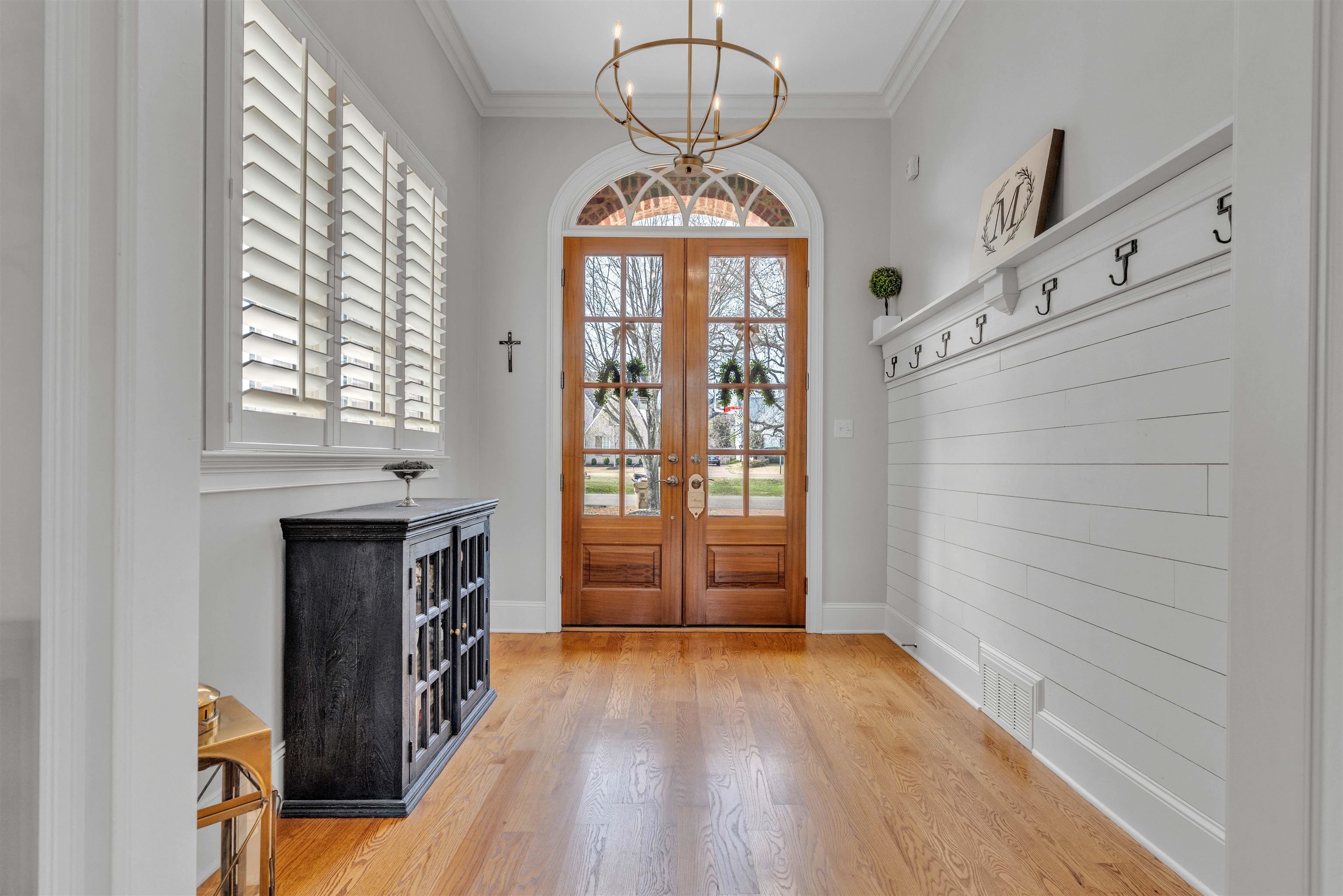 528 Althea Lane Collierville, TN 38017 - Photo 2 of 36 Foyer entrance with french doors, a chandelier, light wood finished floors, and crown molding