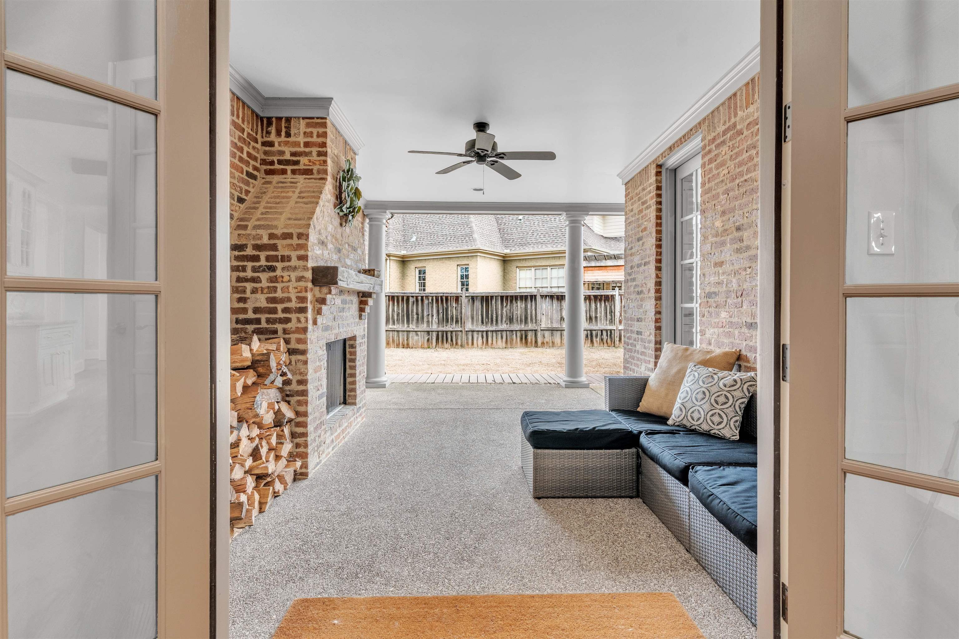 528 Althea Lane Collierville, TN 38017 - Photo 27 of 36 Carpeted living room featuring brick wall, ceiling fan, and ornamental molding
