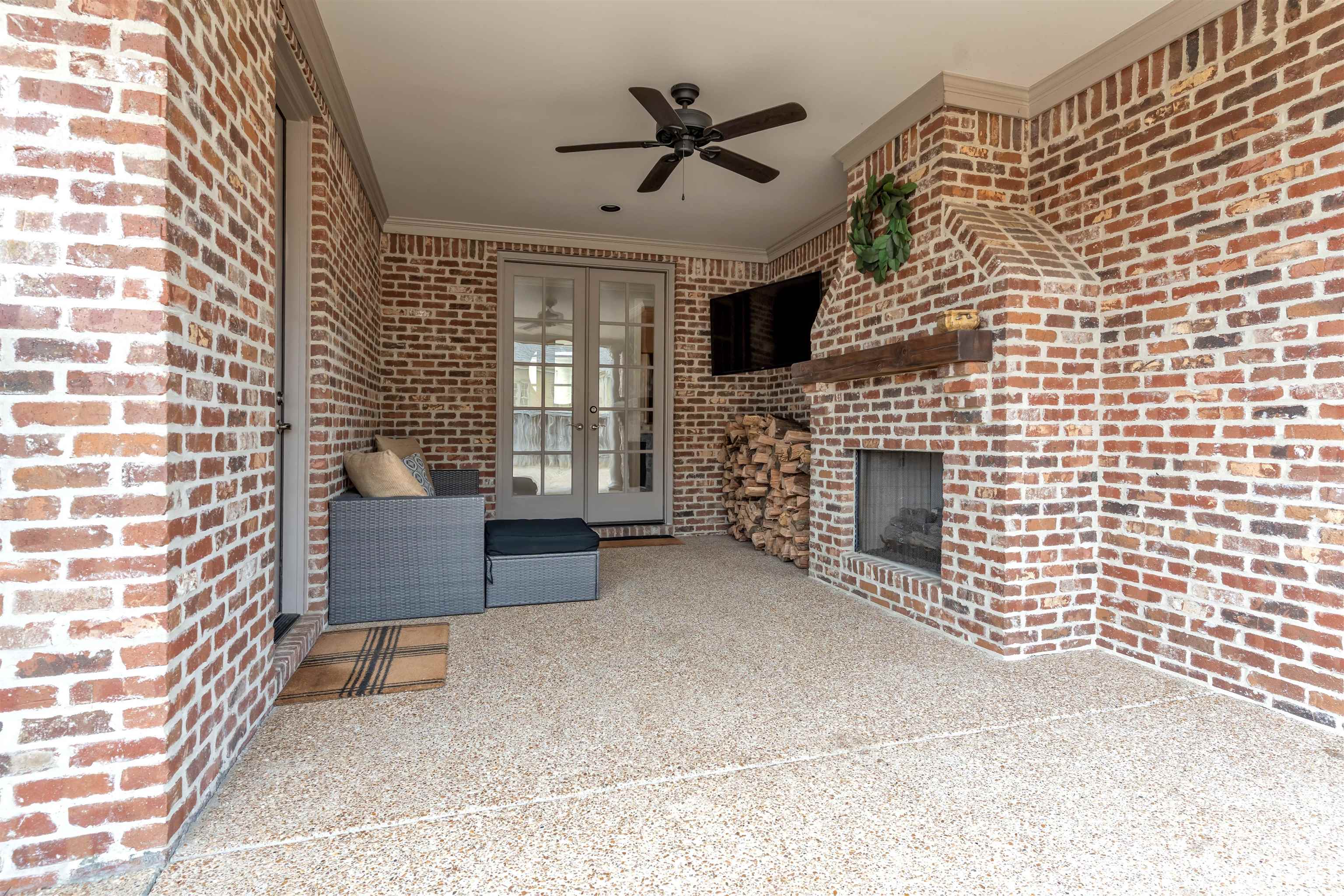 528 Althea Lane Collierville, TN 38017 - Photo 28 of 36 View of patio featuring a brick fireplace, french doors, and ceiling fan