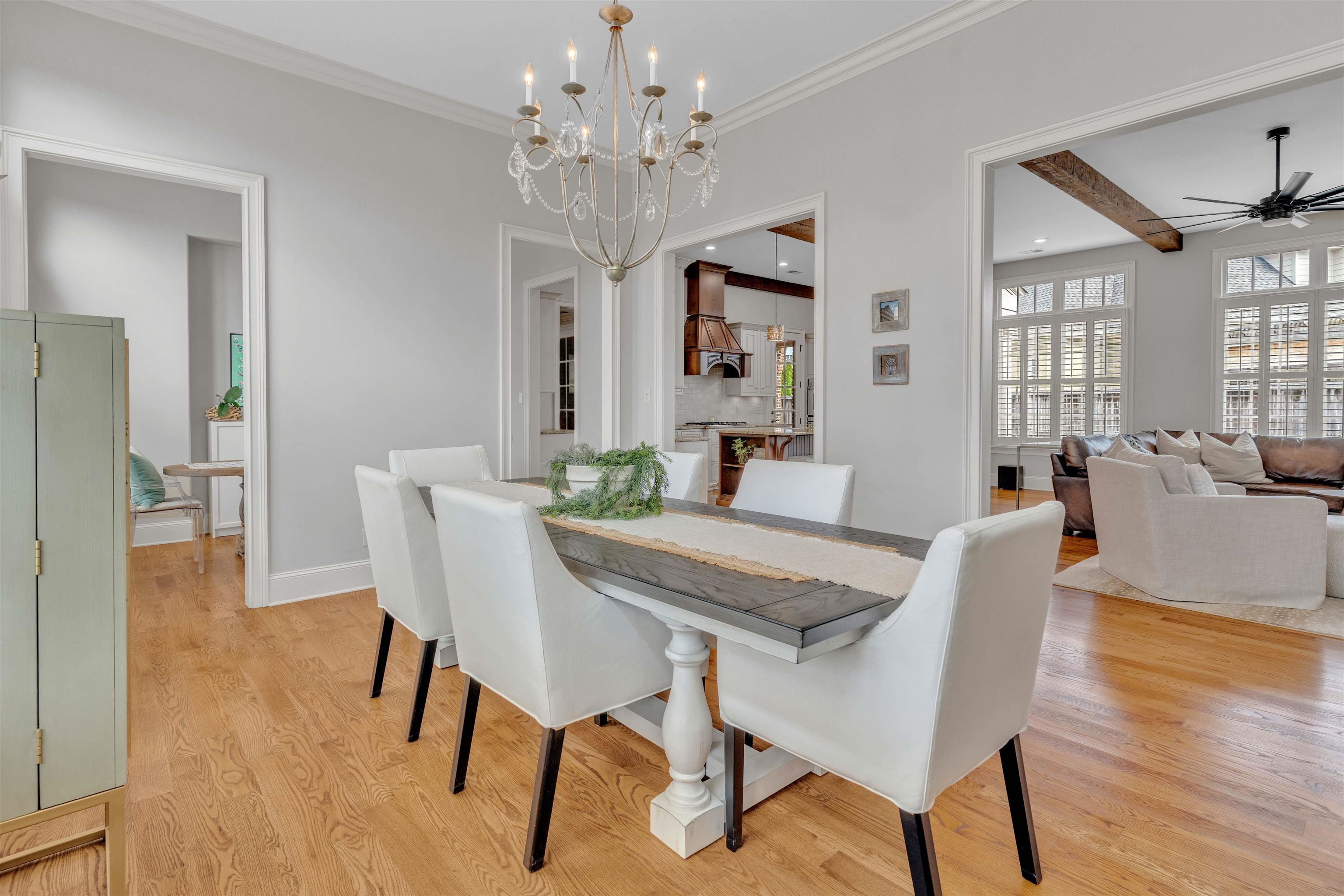 528 Althea Lane Collierville, TN 38017 - Photo 8 of 36 Dining area with suspended lighting, light wood-style floors, a ceiling fan, and crown molding