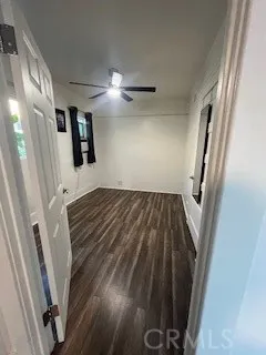 a view of a livingroom with wooden floor and staircase