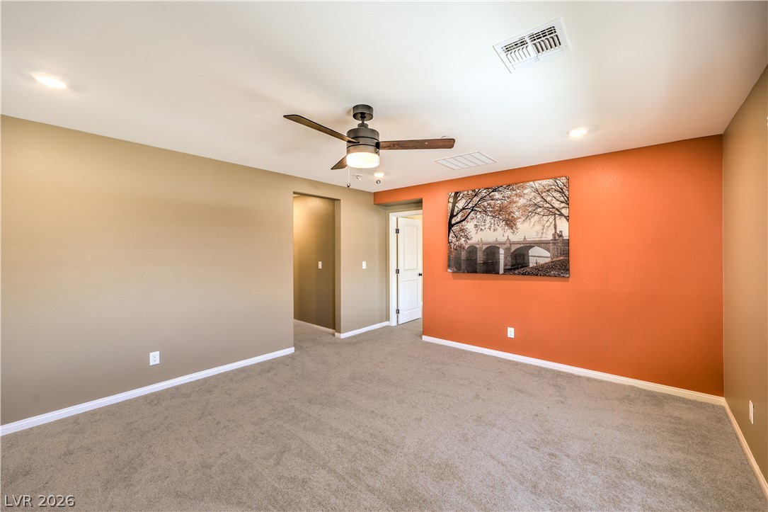3782 Alla Rocca Avenue Henderson, NV 89044 - Photo 20 of 55 This spacious room features neutral walls and plush carpeting, offering a comfortable and versatile living space.