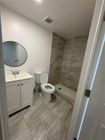 a bathroom with a toilet sink and shower