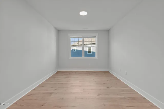 a spacious bathroom with a double vanity sink a mirror and a bathtub