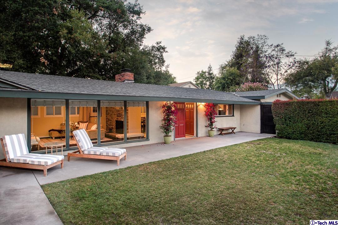 a view of a house with swimming pool and sitting area