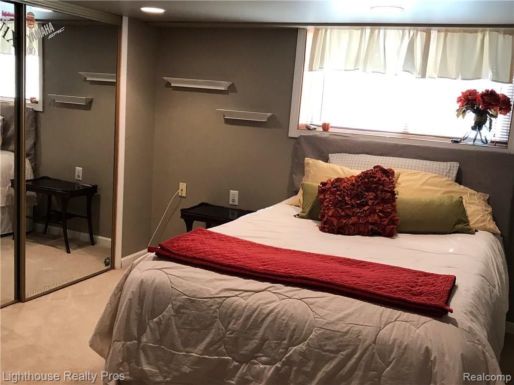 7150 Denton Hill Road Fenton, MI 48430 - Photo 28 of 47 Lower level bedroom with large closet and private bath...and yes, great view!