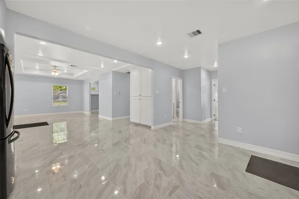 a kitchen with a sink a refrigerator and cabinets