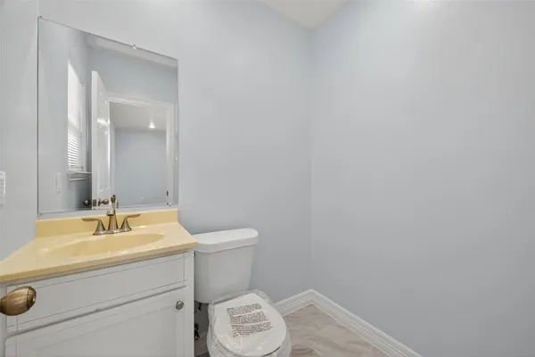 an empty room with wooden floor and window