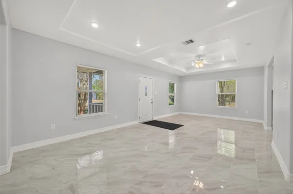 an empty room with windows and closet