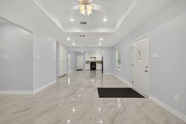 a view of a kitchen with a sink stainless steel appliances and chandelier