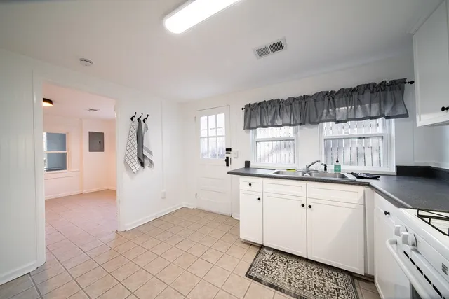a kitchen with granite countertop a sink and cabinets
