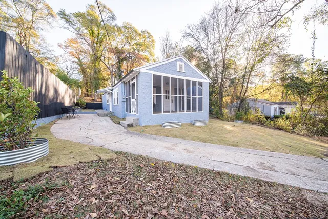 a view of a house with a yard covered in snow