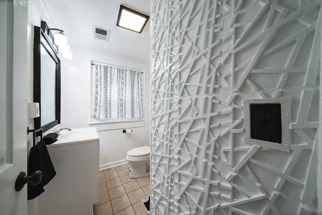 a white toilet sitting next to a bathroom sink