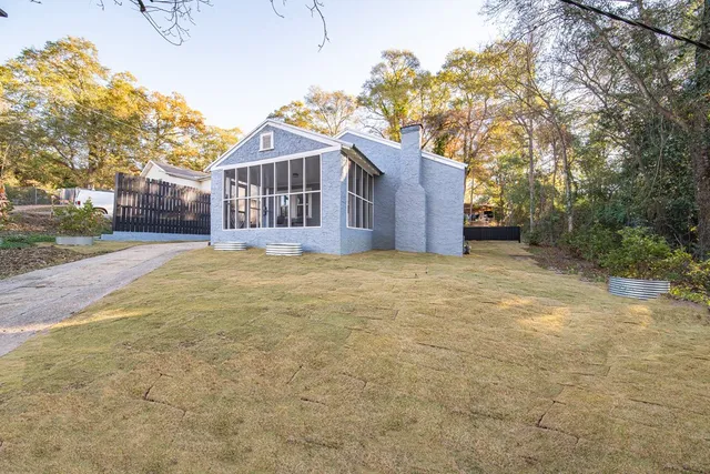 a view of a house with a yard covered in snow