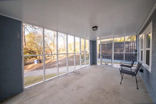 a view of a room with gym equipment and large windows