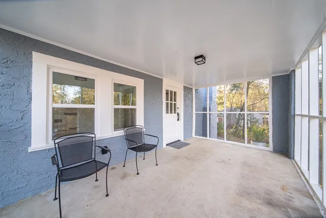 a view of a livingroom with furniture and a window