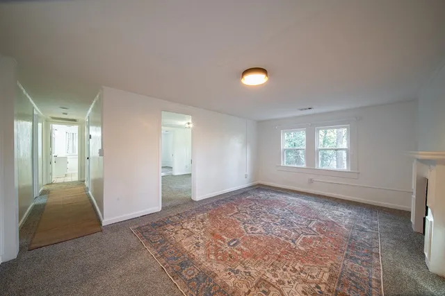 an empty room with windows and closet