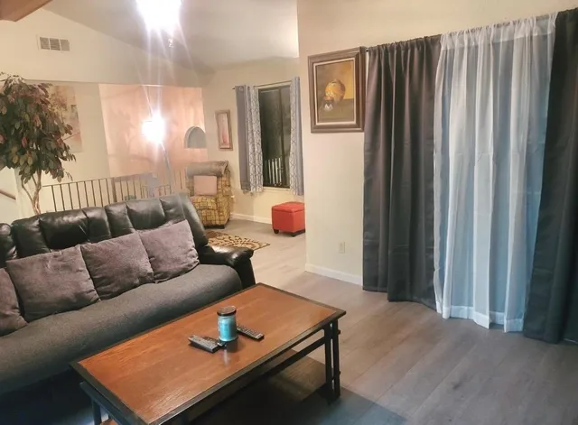 a living room with furniture and a large mirror