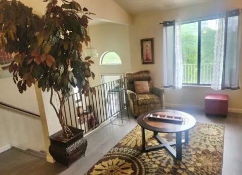 a kitchen with sink a microwave and cabinets