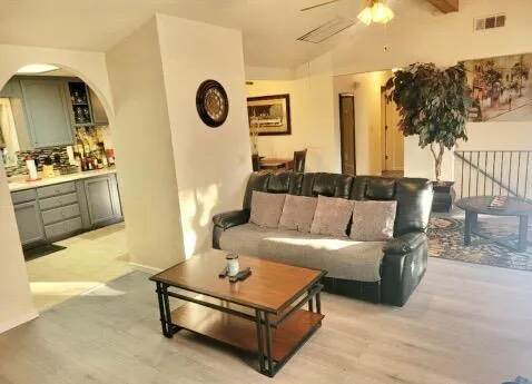 a kitchen with kitchen island granite countertop a sink cabinets and window